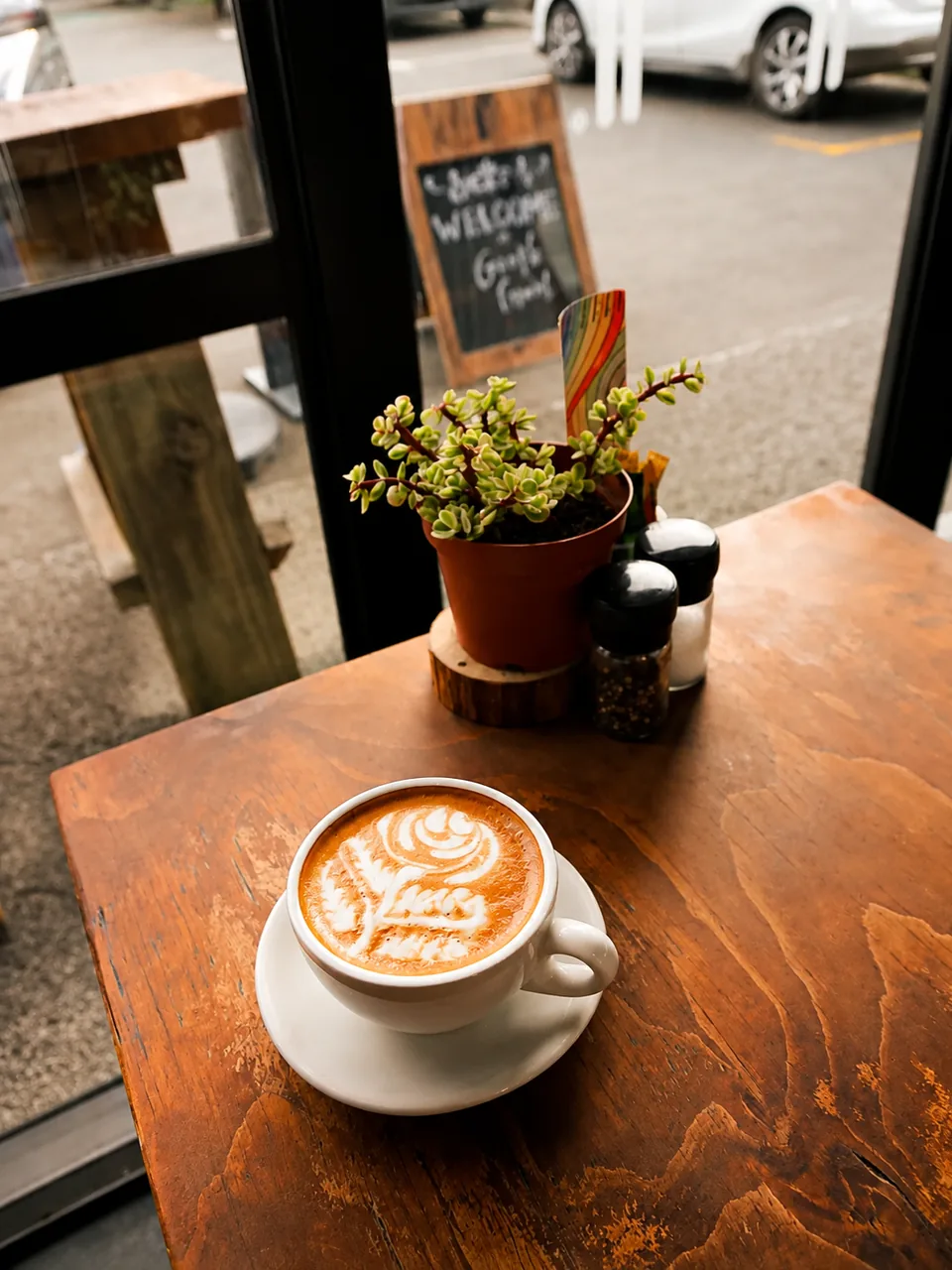 A cup of coffee by the cafe entrance