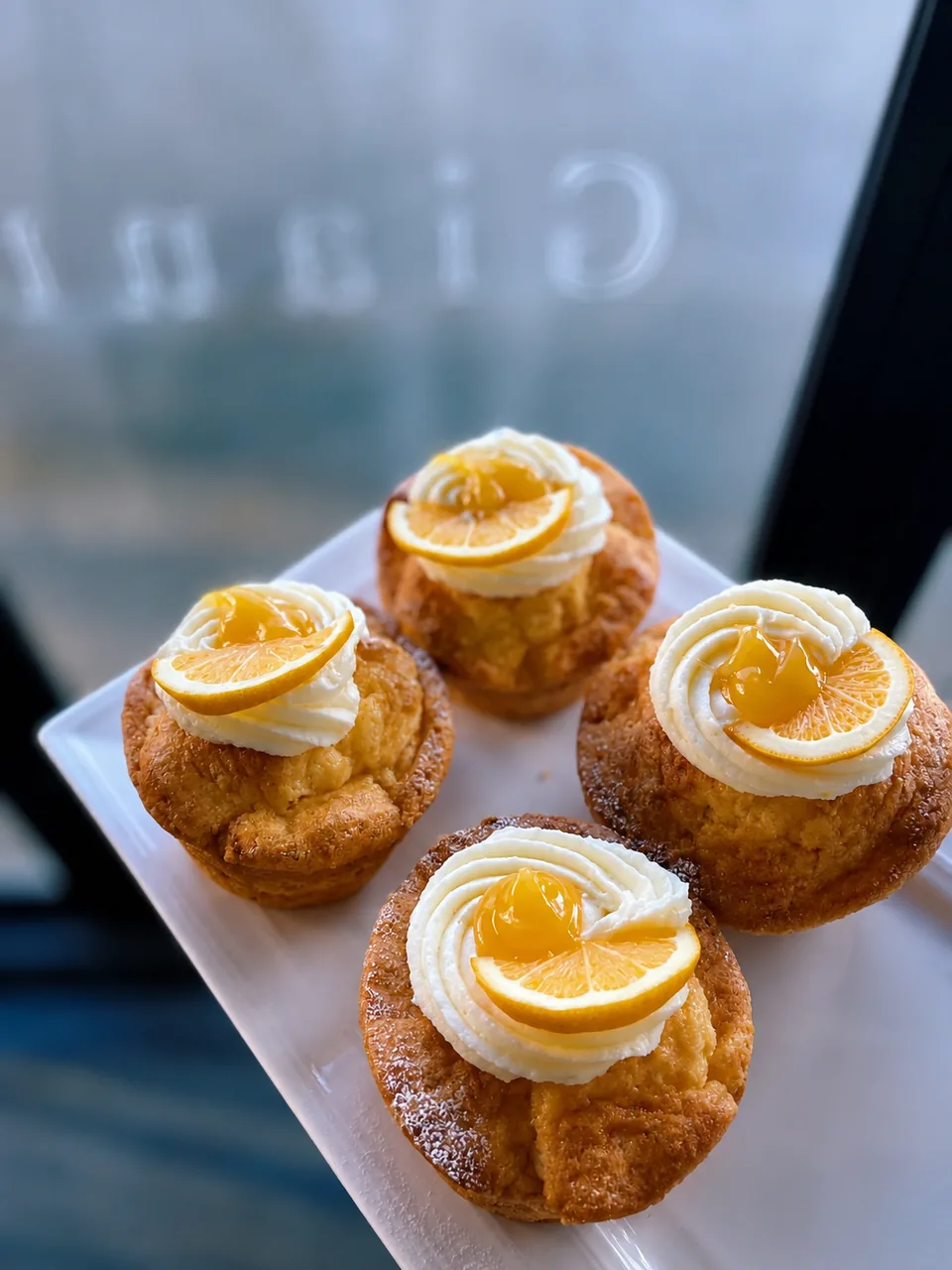 Small cakes topped with cream and lemon slices at Gentle Giant Cafe